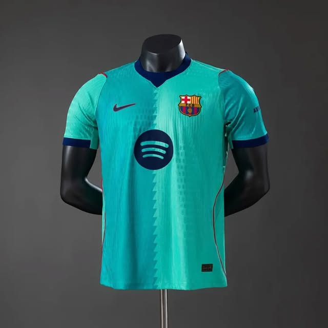 Turquoise Barcelona-marked football jersey on a black mannequin.