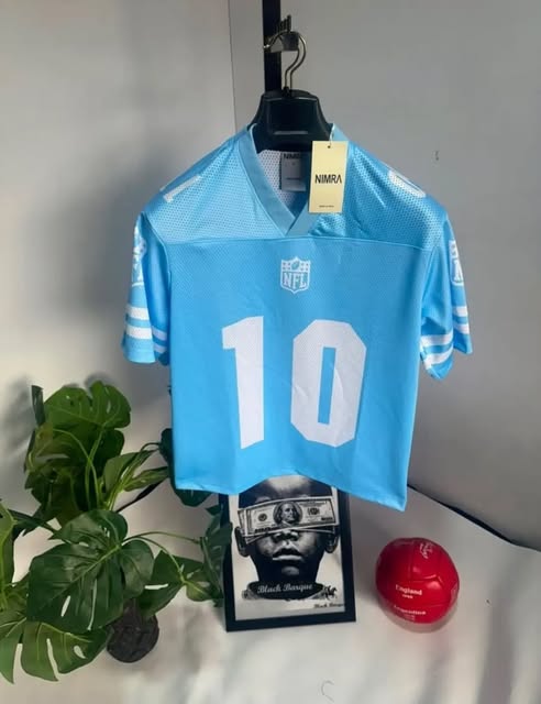 Sky blue V-neck sports jersey with a white number 10 and white sleeve stripes.